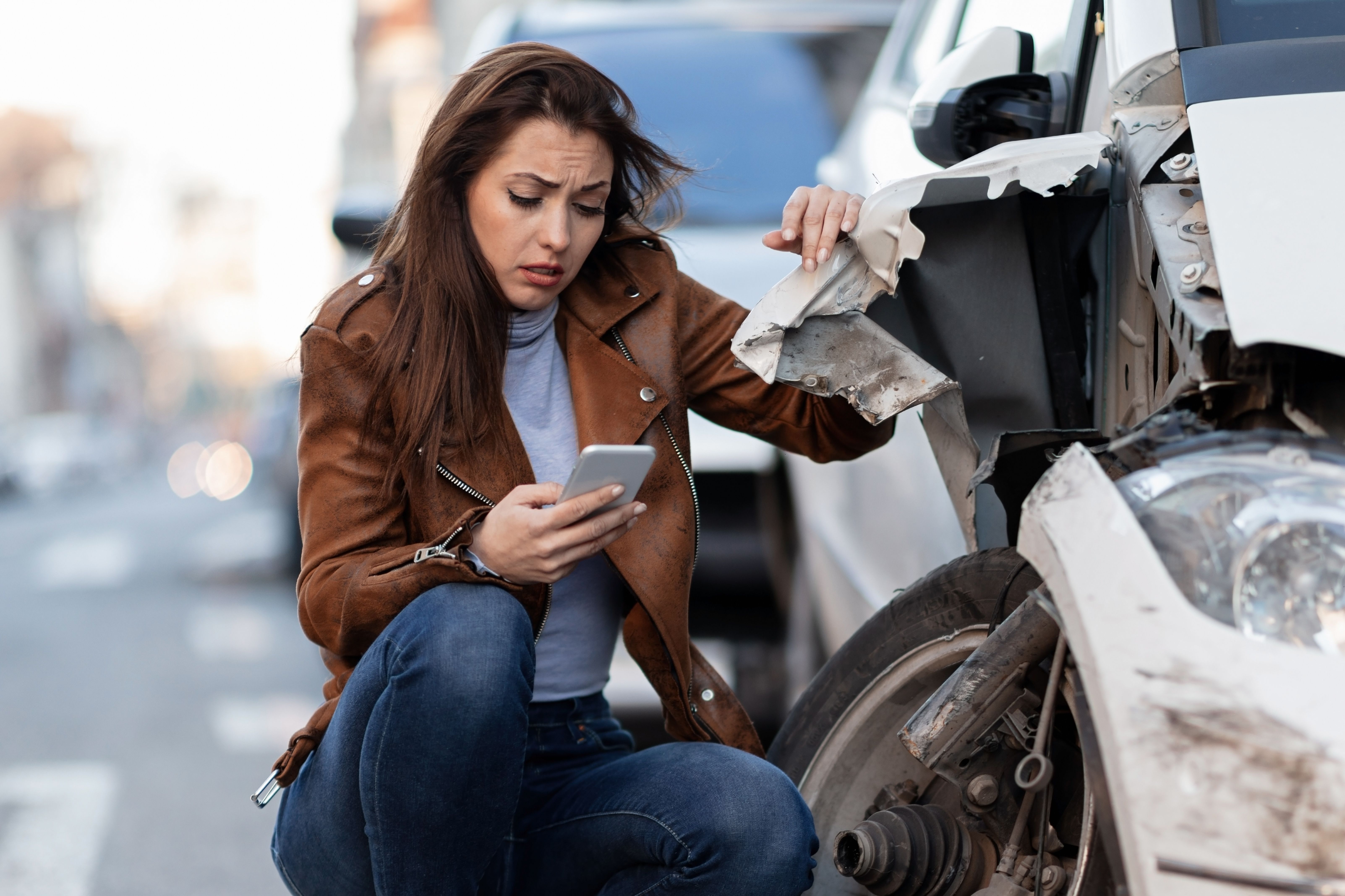 young-sad-woman-text-messaging-smart-after-car-crash-road.jpg